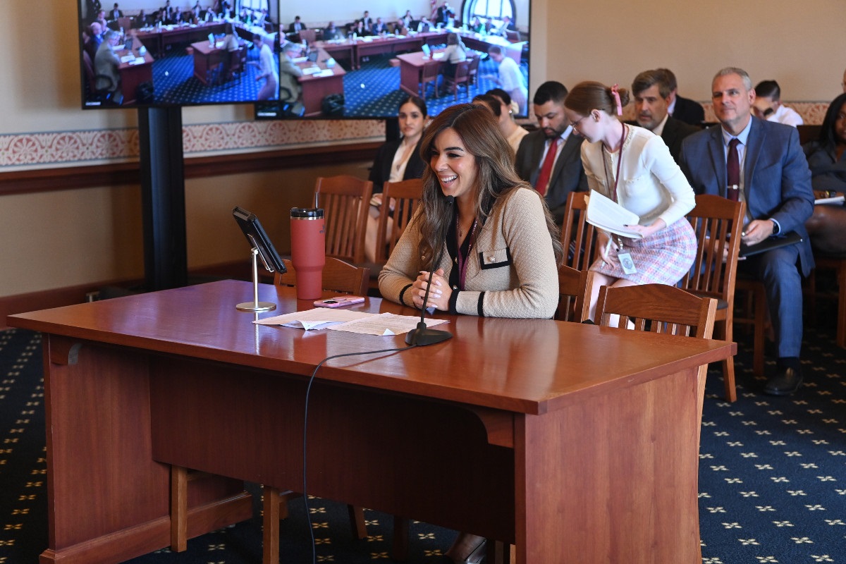 Senator Toro speaks while seated at a desk in a committee hearing room.